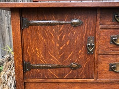 Detail hand hammered copper strap hinges on door.